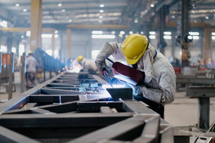 A steel worker welding a beam