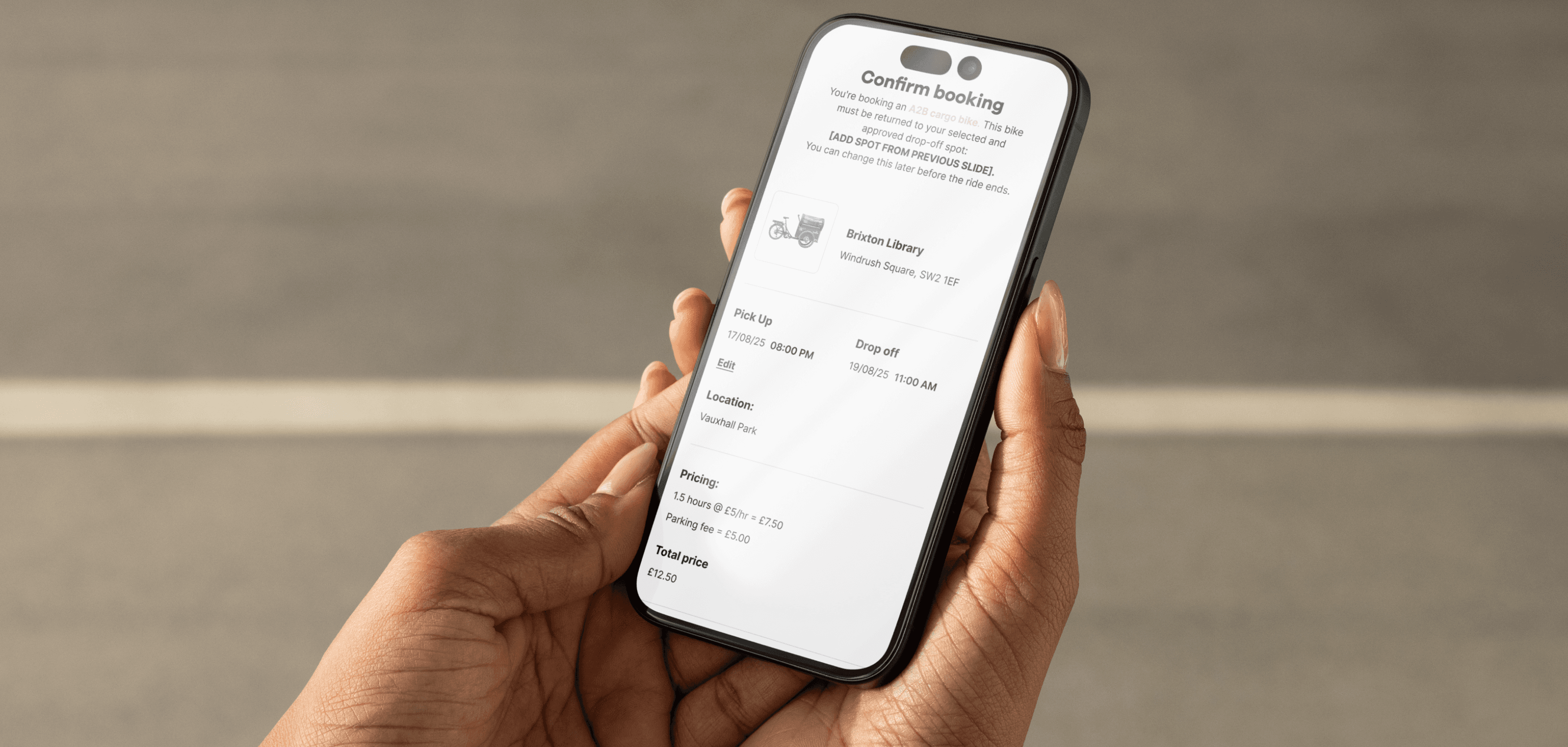 A person holding a phone using the our bike app
