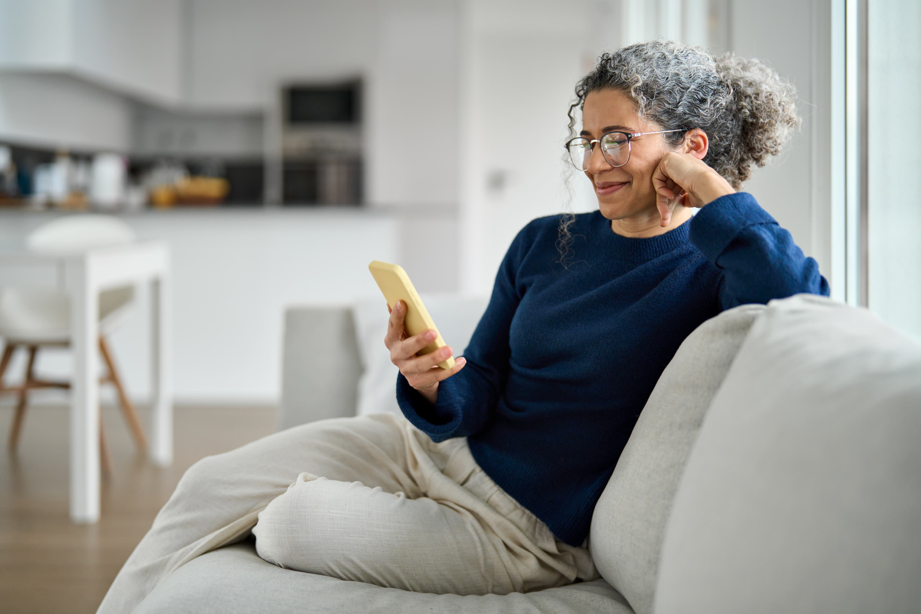 A man on a couch with an orange phone