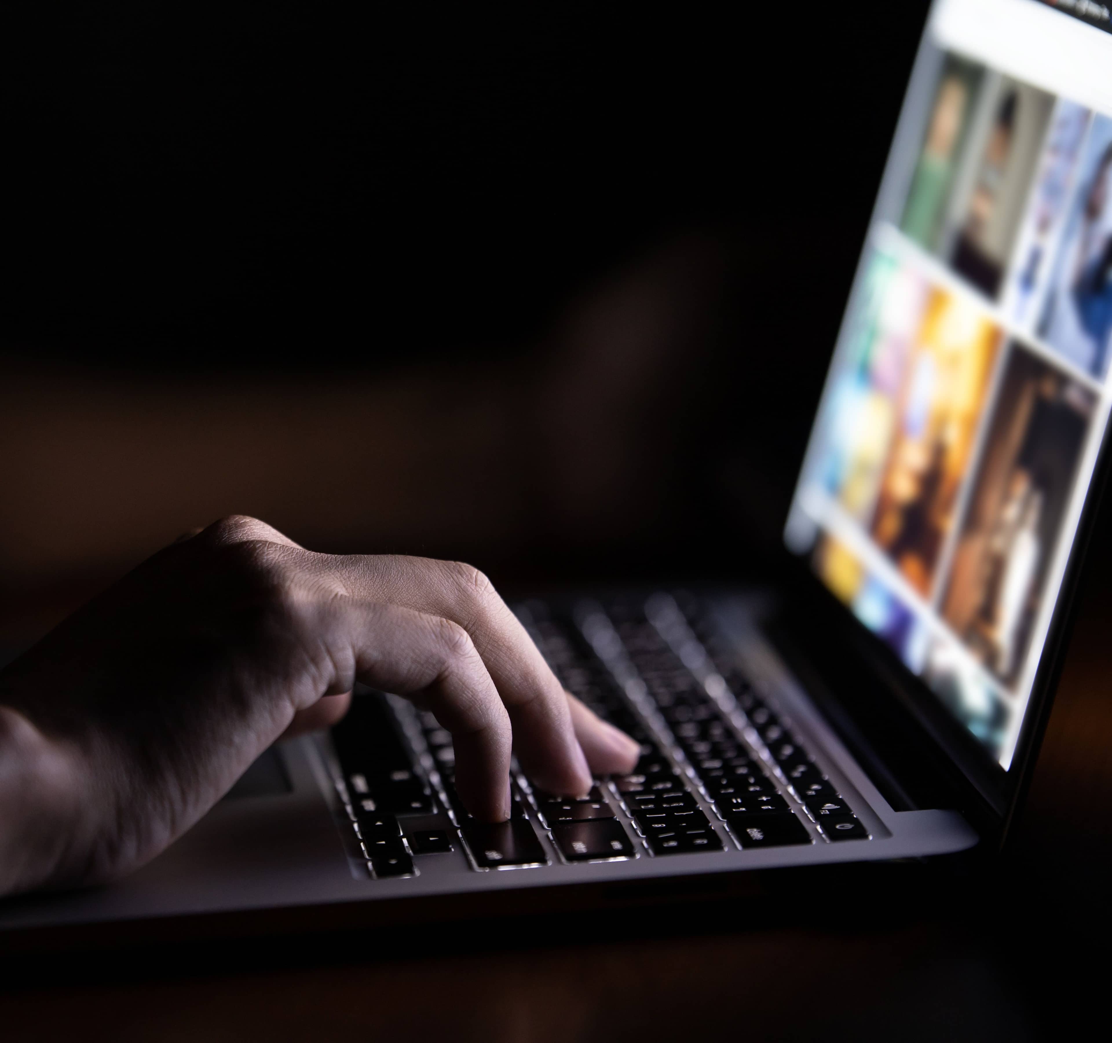 Someone using a laptop at night